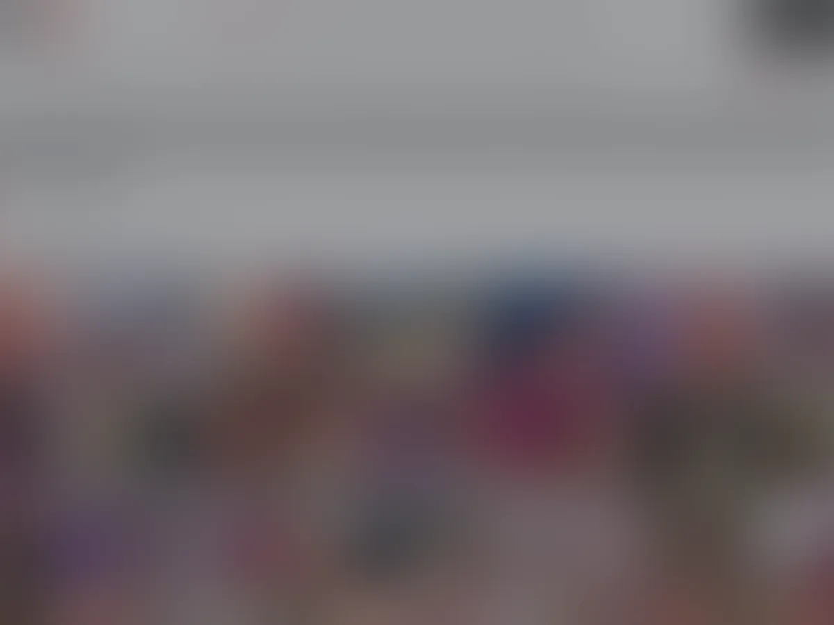 A heavily blurred, censored capture of the XVideos Cams homepage — only soft shapes are visible, no explicit or readable content