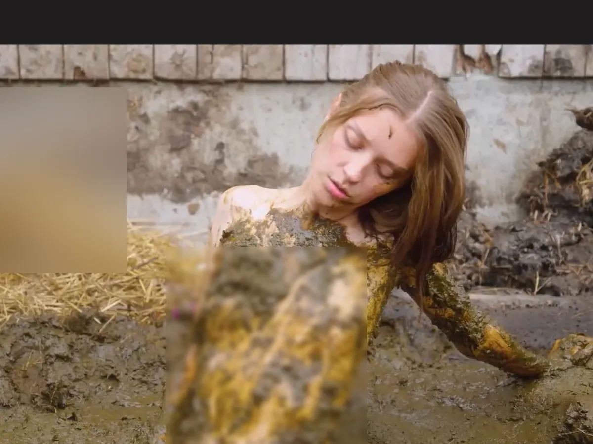 A heavily blurred, censored capture of the ManureFetish homepage โ only soft shapes are visible, no explicit or readable content