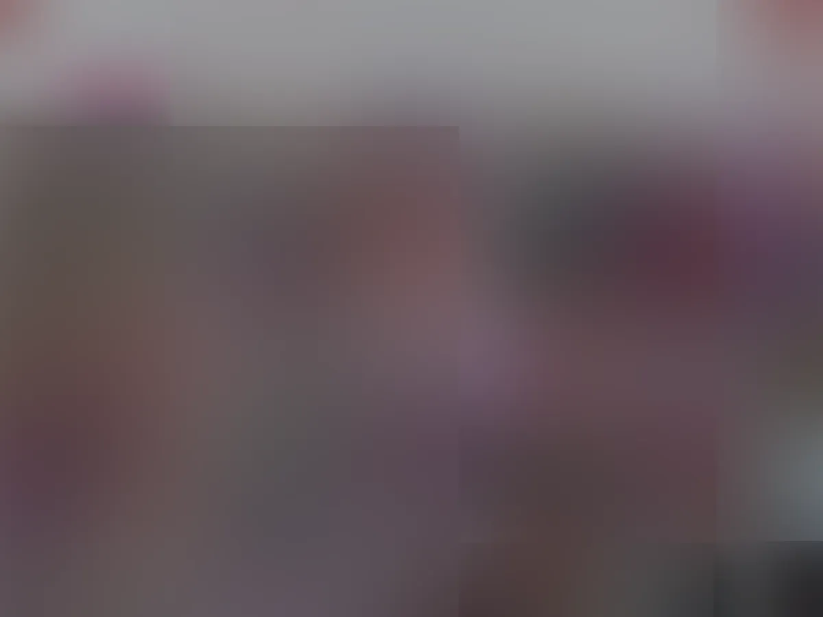 A heavily blurred, censored capture of the Naked.com homepage — only soft shapes are visible, no explicit or readable content